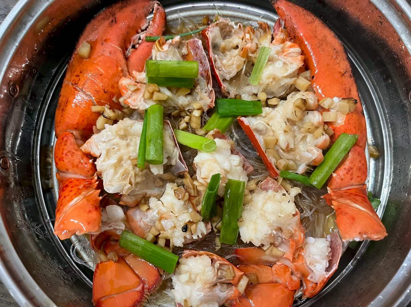 Homemade steamed lobster over vermicelli with garlic and scallions